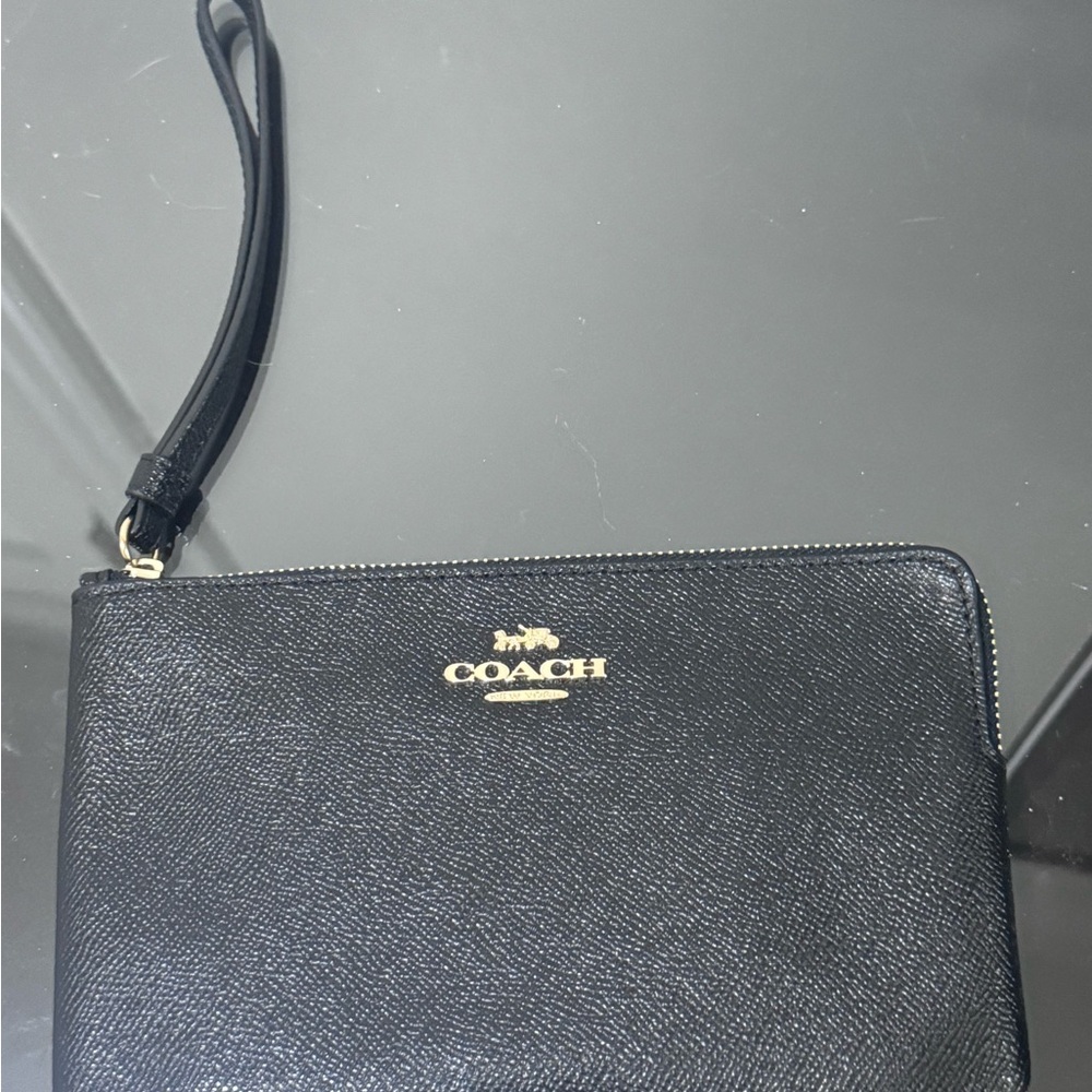 Coach - never used. Black Pebbled Leather Wristlet with Gold Logo
